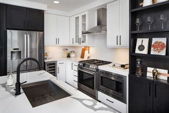a kitchen with white countertops and black cabinets